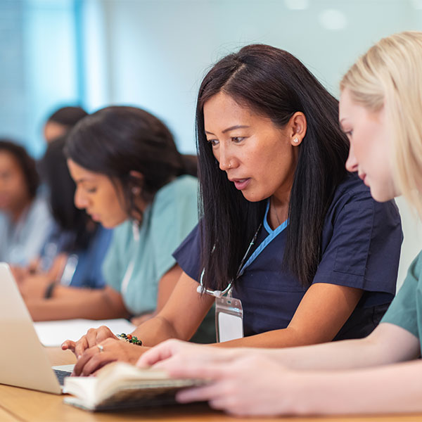 medical professionals working on laptop